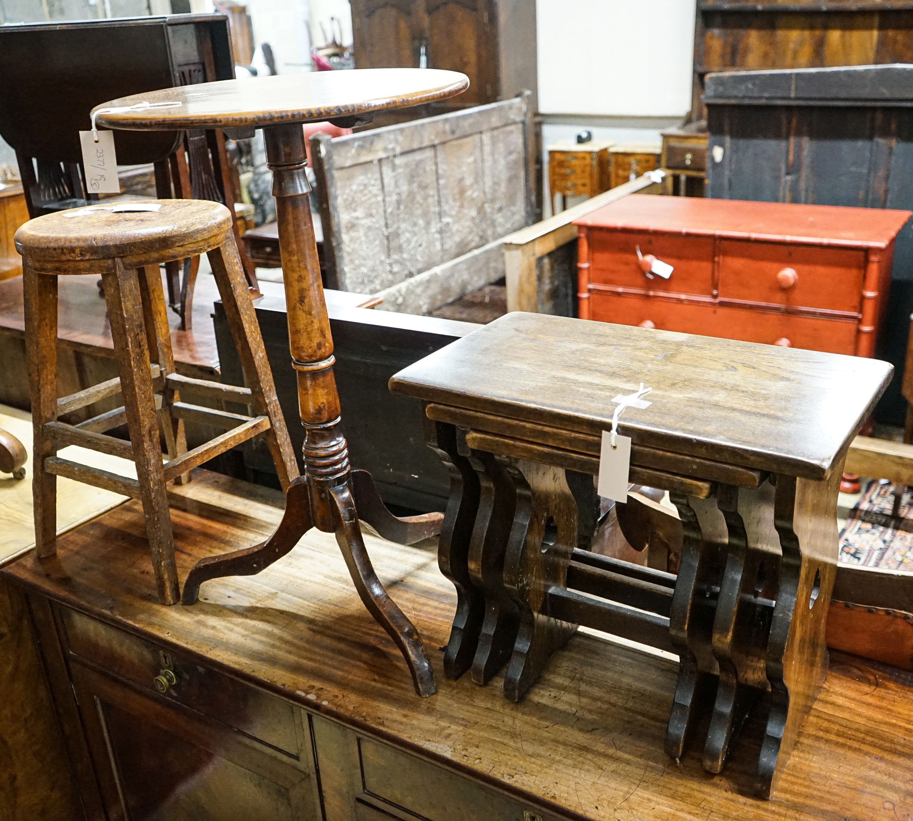 A 19th century circular mahogany tripod wine table, diameter 45cm, height 74cm, together with a nest of tea tables, and a provincial tall oak stool